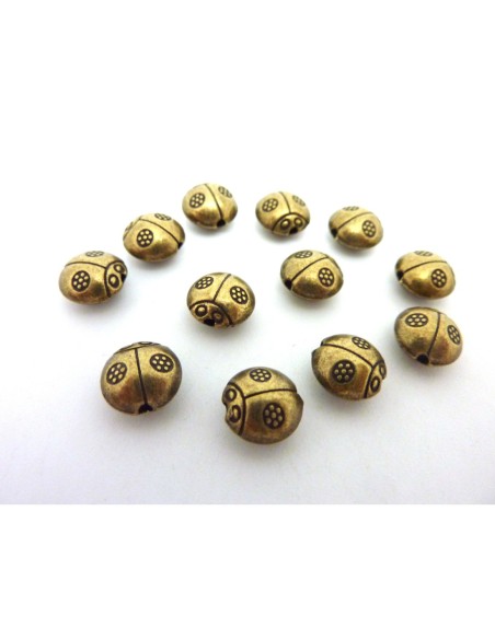 perle coccinelle en metal de couleur bronze