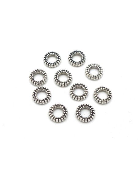 Perle rondelle en métal argenté travaillé