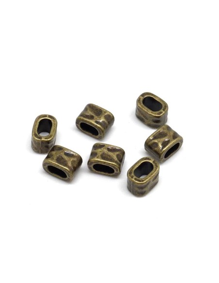 Perle poussoir pour lanière cuir de 5mm martelé en métal de couleur bronze